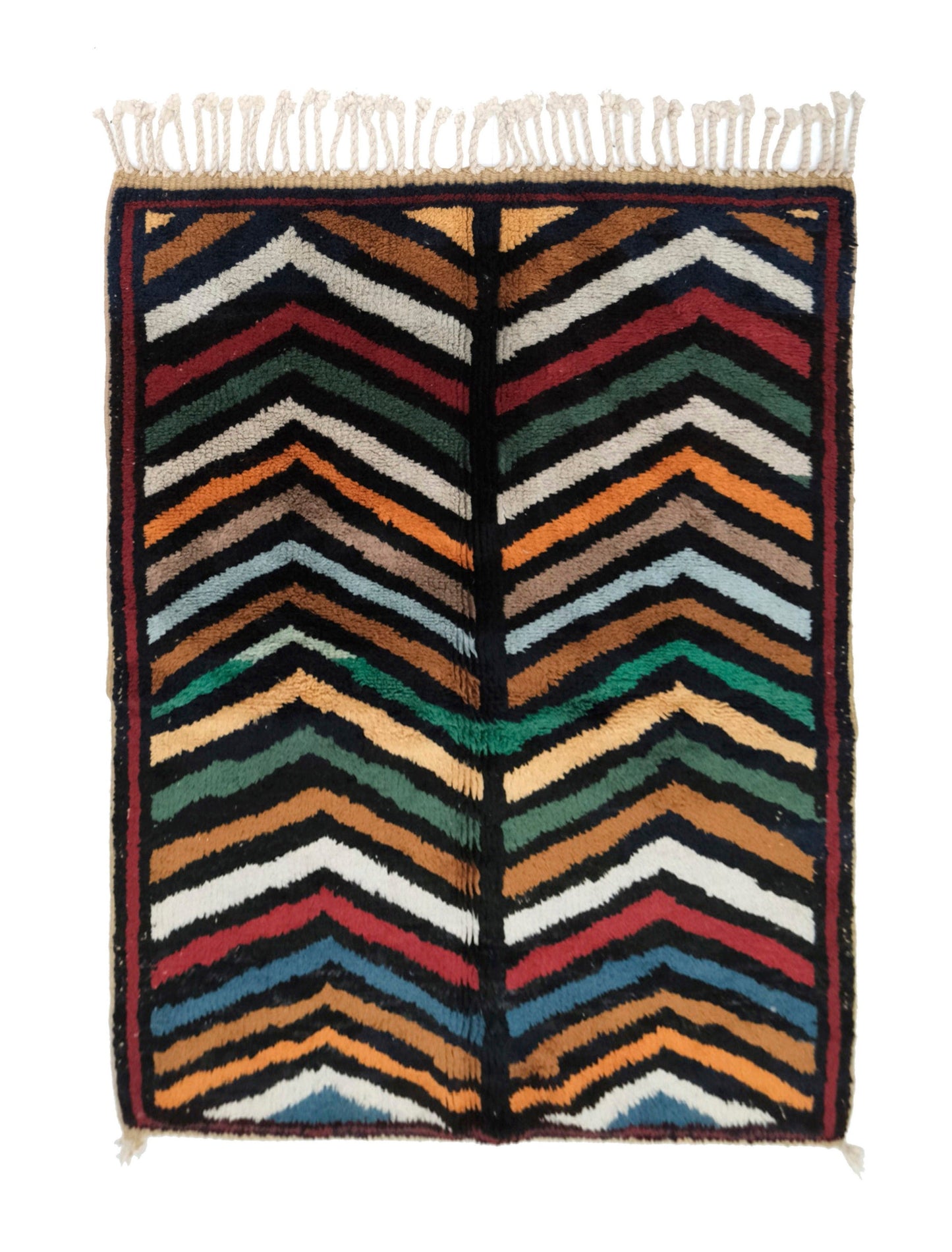 Plush handwoven Moroccan Azilal wool rug with colorful chevron zigzag stripes in pink, orange, navy, and mint, featuring a central dark navy spine with horizontal notches, finished with top fringe and small corner ties, displayed on a white background.