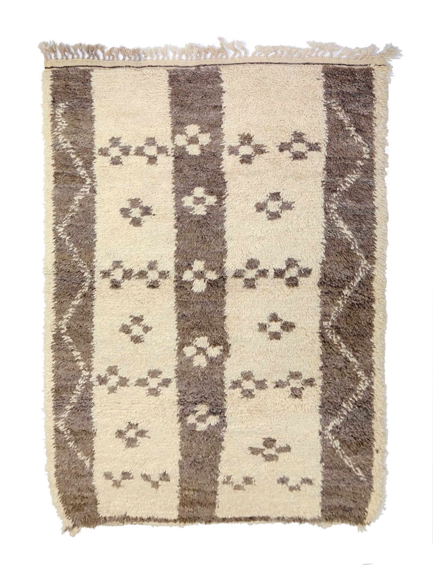 Plush cream and taupe hand-knotted Moroccan Azilal wool rug featuring alternating vertical stripes with floral tribal motifs, a wavy zigzag border on the sides, a twisted top fringe, and a small bottom corner tie, displayed on a white background.