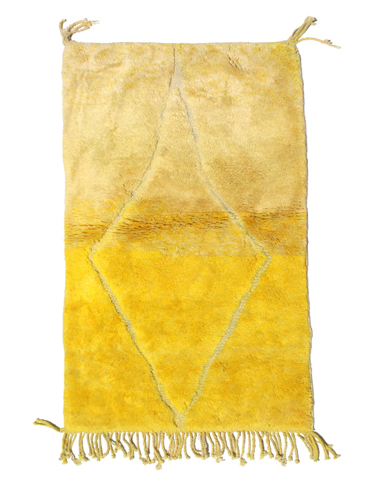 Hand-knotted Moroccan wool rug featuring an ombré effect fading from cream to yellow, with a large central cream diamond and natural fringed edges.

