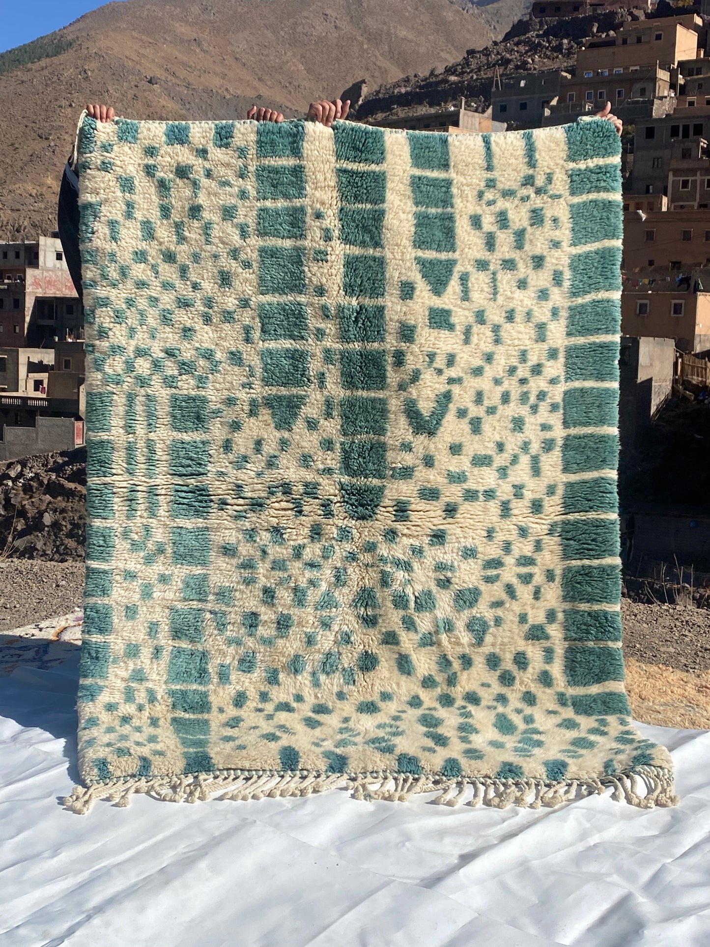 Beni Ourain rugs originate from the Atlas Mountains of Morocco and are characterized by their distinctive, neutral-toned, and geometric designs. These handwoven rugs often feature a plush pile and are made by the Berber tribes,  size is 215x160 cm