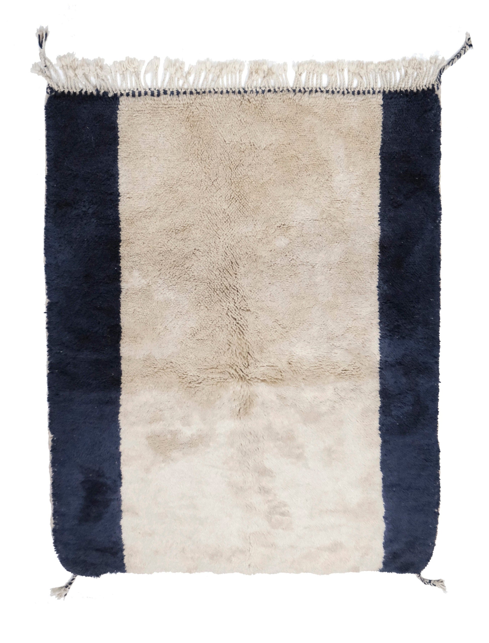 Plush wool rug featuring a wide cream center framed by thick navy blue vertical border stripes, finished with a top cream fringe and braided corner tassels, displayed on a white background.