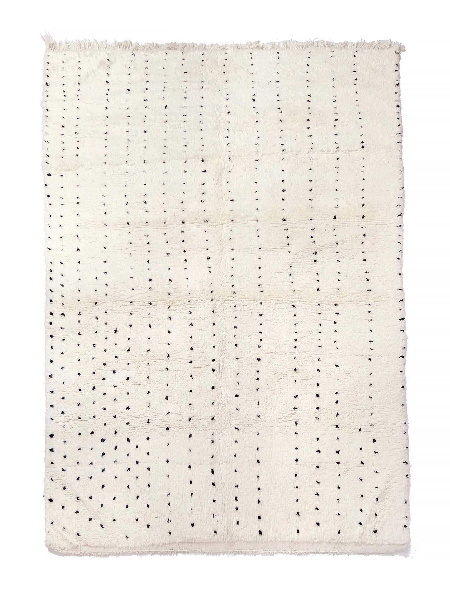 Plush cream wool rug featuring vertical dashed lines made of hand-knotted black dots and a short fringe along the top edge, displayed on a white background.

