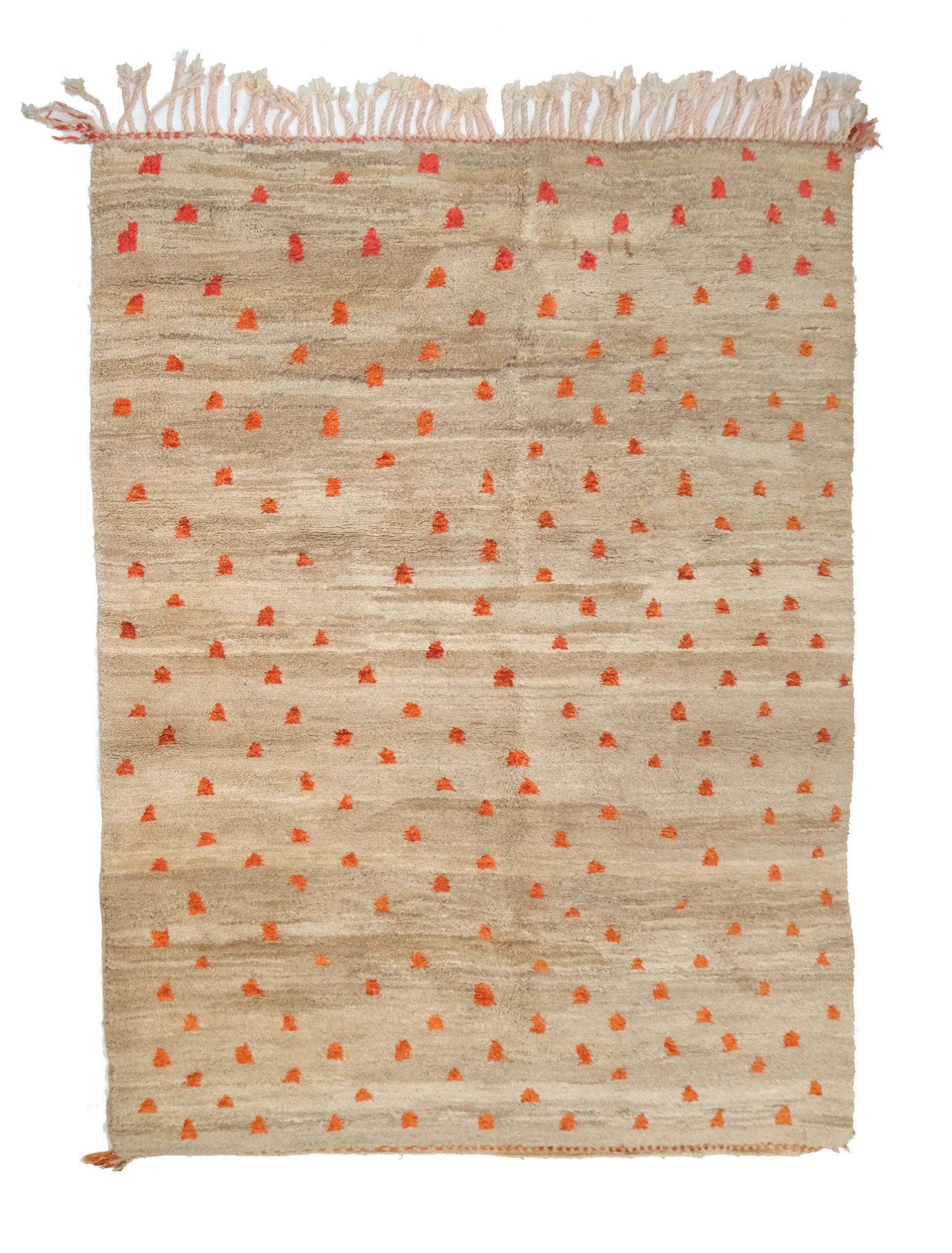 Plush hand-knotted taupe and camel wool rug featuring a subtle central seam and a scatter of vibrant orange and rust-colored primitive tribal symbols, with a twisted top fringe and small braided corner ties, displayed on a white background.