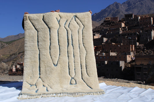 Beni Ourain rugs originate from the Atlas Mountains of Morocco and are characterized by their distinctive, neutral-toned, and geometric designs. These handwoven rugs often feature a plush pile and are made by the Berber tribes,  size is 215x160 cm