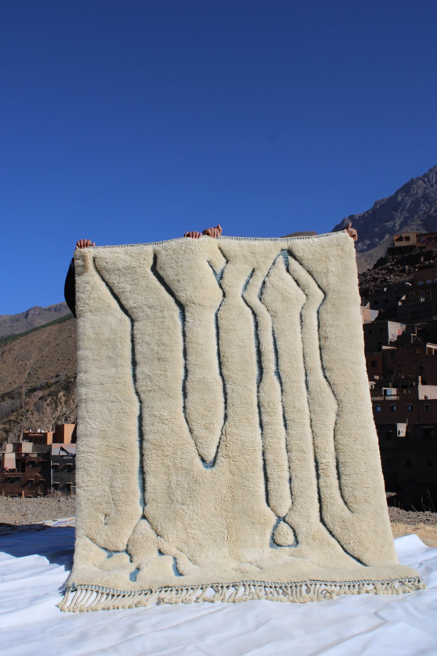 Beni Ourain rugs originate from the Atlas Mountains of Morocco and are characterized by their distinctive, neutral-toned, and geometric designs. These handwoven rugs often feature a plush pile and are made by the Berber tribes,  size is 215x160 cm