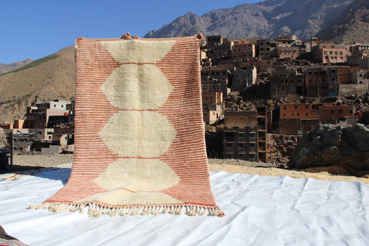 Beni Ourain rugs originate from the Atlas Mountains of Morocco and are characterized by their distinctive, neutral-toned, and geometric designs. These handwoven rugs often feature a plush pile and are made by the Berber tribes,  size is 255x150 cm