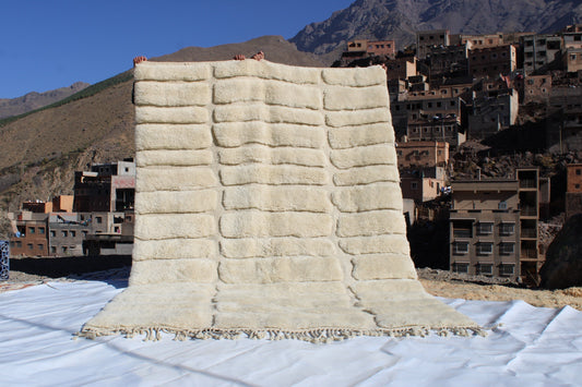 Beni Ourain rugs originate from the Atlas Mountains of Morocco and are characterized by their distinctive, neutral-toned, and geometric designs. These handwoven rugs often feature a plush pile and are made by the Berber tribes,  size is 285x195 cm