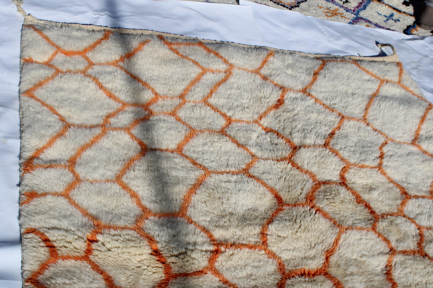 Beni Ourain rugs originate from the Atlas Mountains of Morocco and are characterized by their distinctive, neutral-toned, and geometric designs. These handwoven rugs often feature a plush pile and are made by the Berber tribes,  size is 255x155 cm