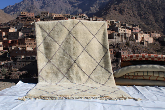 Beni Ourain rugs originate from the Atlas Mountains of Morocco and are characterized by their distinctive, neutral-toned, and geometric designs. These handwoven rugs often feature a plush pile and are made by the Berber tribes,  size is 310x200 cm