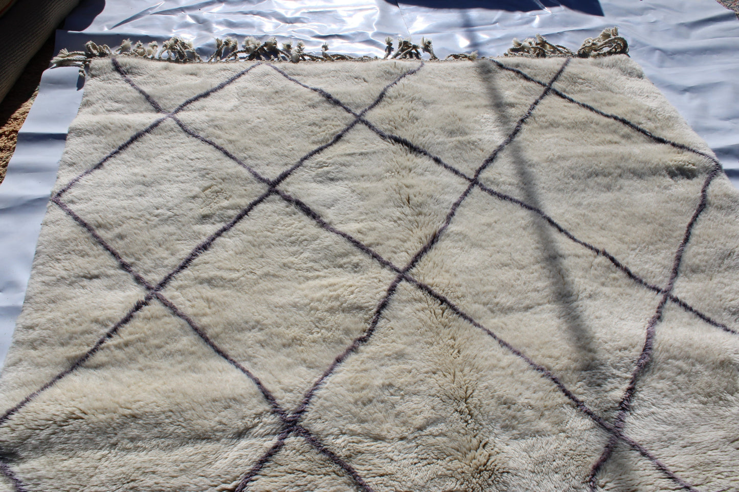 Beni Ourain rugs originate from the Atlas Mountains of Morocco and are characterized by their distinctive, neutral-toned, and geometric designs. These handwoven rugs often feature a plush pile and are made by the Berber tribes,  size is 310x200 cm