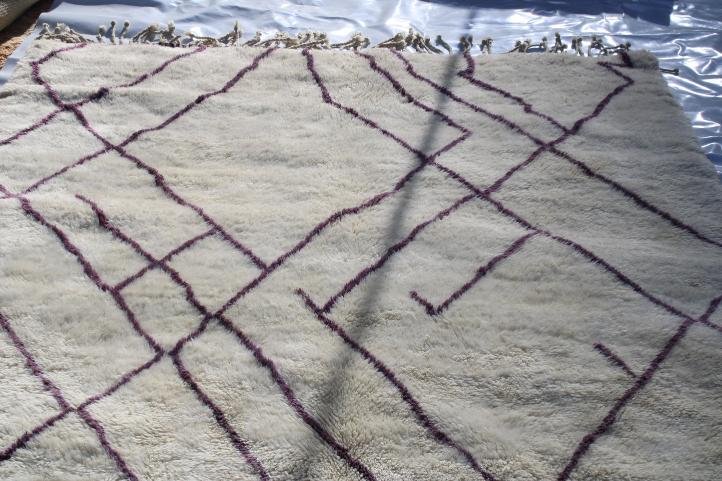 Beni Ourain rugs originate from the Atlas Mountains of Morocco and are characterized by their distinctive, neutral-toned, and geometric designs. These handwoven rugs often feature a plush pile and are made by the Berber tribes,  size is 310x210 cm