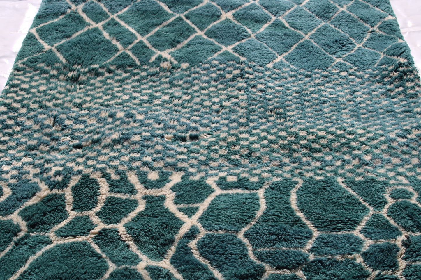 Beni Ourain rugs originate from the Atlas Mountains of Morocco and are characterized by their distinctive, neutral-toned, and geometric designs. These handwoven rugs often feature a plush pile and are made by the Berber tribes,  size is 250x150cm