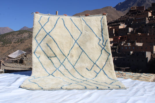 Beni Ourain rugs originate from the Atlas Mountains of Morocco and are characterized by their distinctive, neutral-toned, and geometric designs. These handwoven rugs often feature a plush pile and are made by the Berber tribes,  size is 270x192 cm