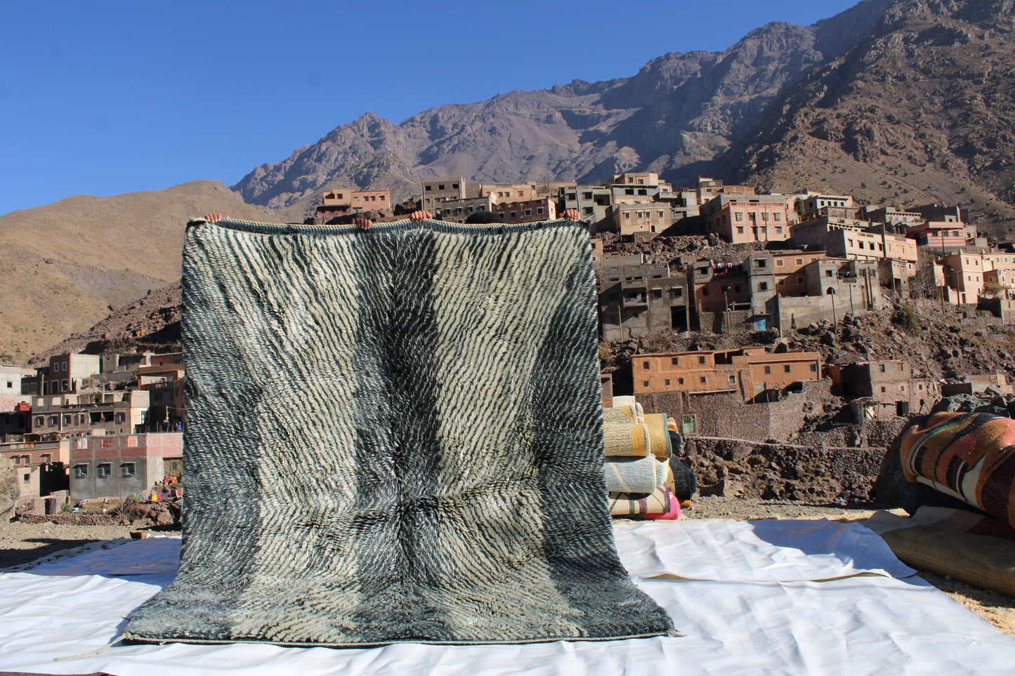 Beni Ourain rugs originate from the Atlas Mountains of Morocco and are characterized by their distinctive, neutral-toned, and geometric designs. These handwoven rugs often feature a plush pile and are made by the Berber tribes,  size is 254x190 cm