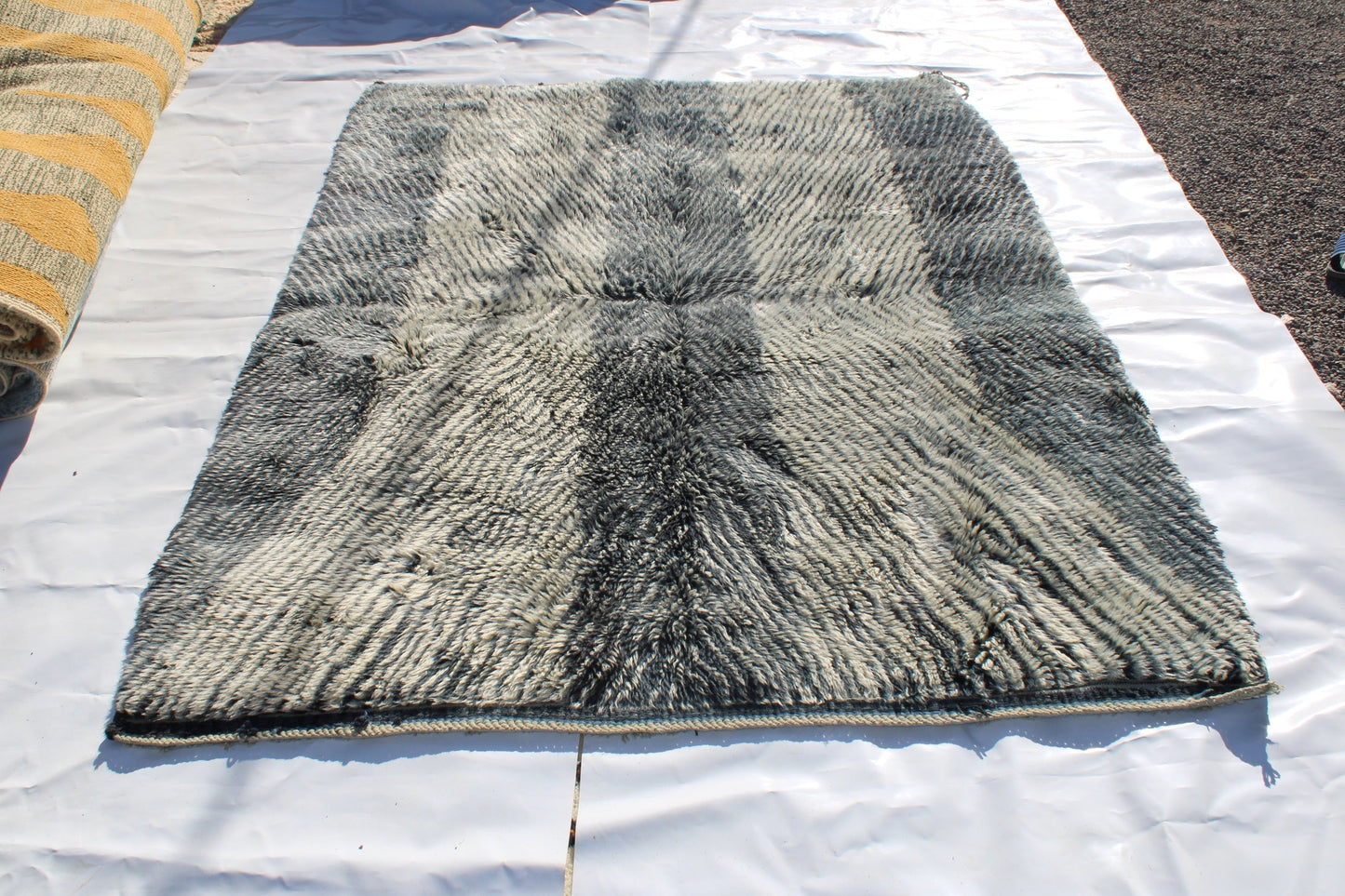 Beni Ourain rugs originate from the Atlas Mountains of Morocco and are characterized by their distinctive, neutral-toned, and geometric designs. These handwoven rugs often feature a plush pile and are made by the Berber tribes,  size is 254x190 cm