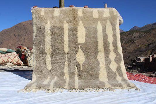 Beni Ourain rugs originate from the Atlas Mountains of Morocco and are characterized by their distinctive, neutral-toned, and geometric designs. These handwoven rugs often feature a plush pile and are made by the Berber tribes,  size is 280x177 cm