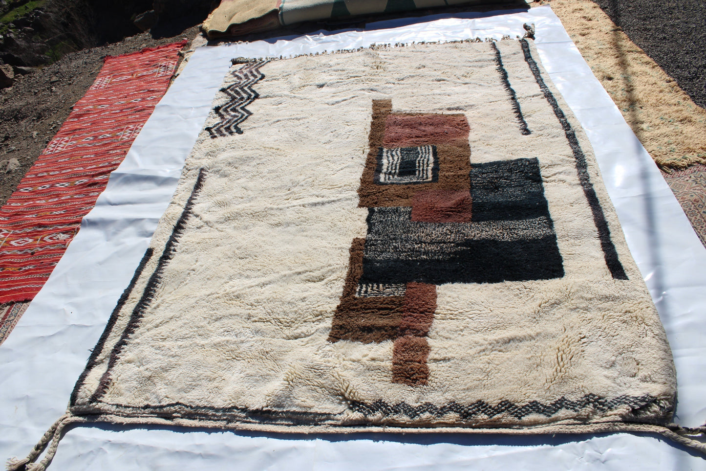 Beni Ourain rugs originate from the Atlas Mountains of Morocco and are characterized by their distinctive, neutral-toned, and geometric designs. These handwoven rugs often feature a plush pile and are made by the Berber tribes,  size is 280x177 cm