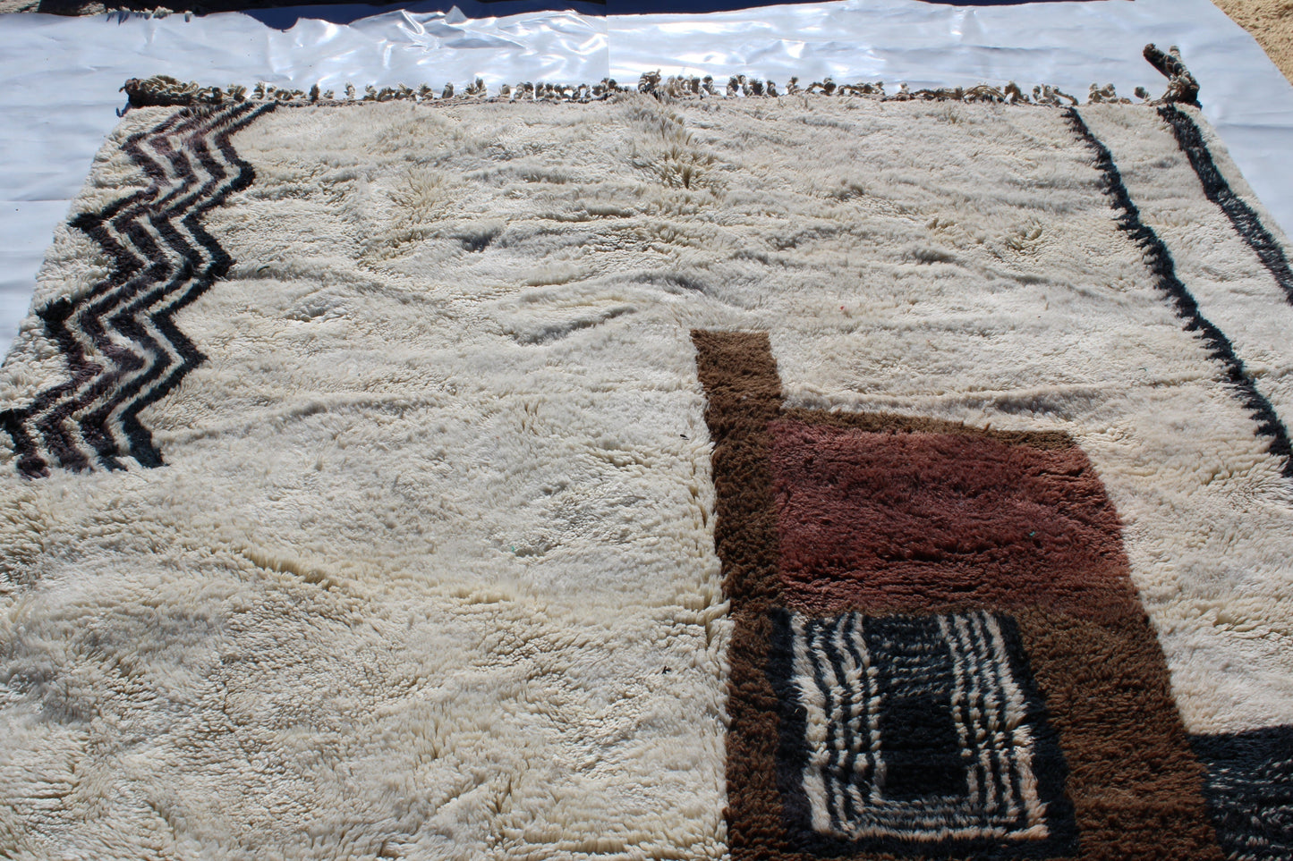 Beni Ourain rugs originate from the Atlas Mountains of Morocco and are characterized by their distinctive, neutral-toned, and geometric designs. These handwoven rugs often feature a plush pile and are made by the Berber tribes,  size is 280x177 cm